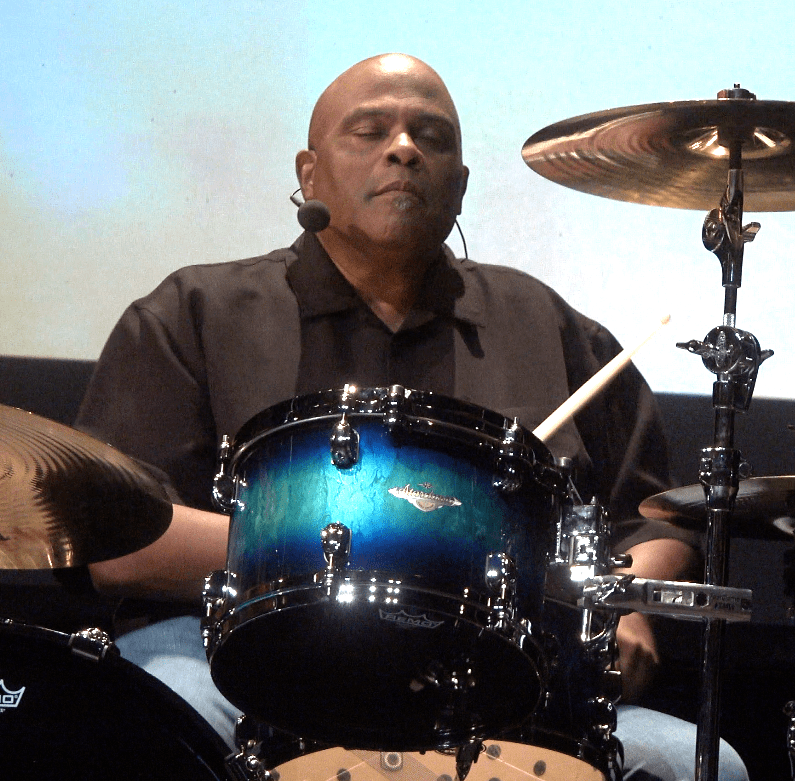 Mark Ellis behind drums eyes closed